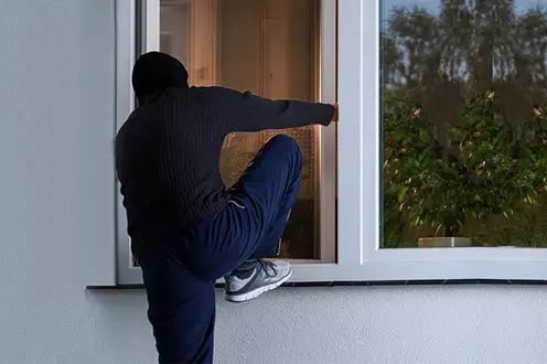 burglar-breaking-into-house-through-window copy