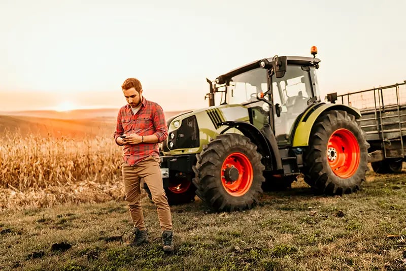 A farmer using his alarm app to arm his alarm as part of an advanced rural security solution
