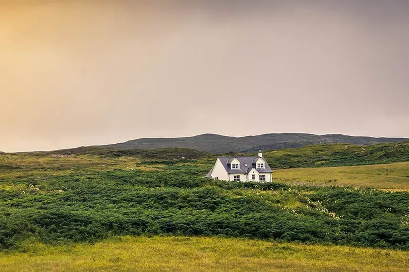 Isolated countryside house overlooking rolling fields in rural Ireland