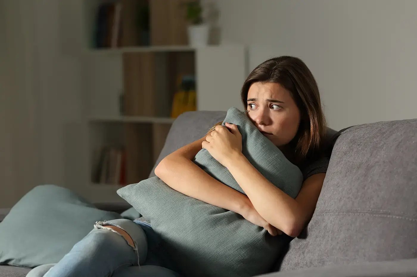 woman on couch scared