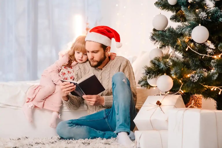 man on couch with daughter reading book-1