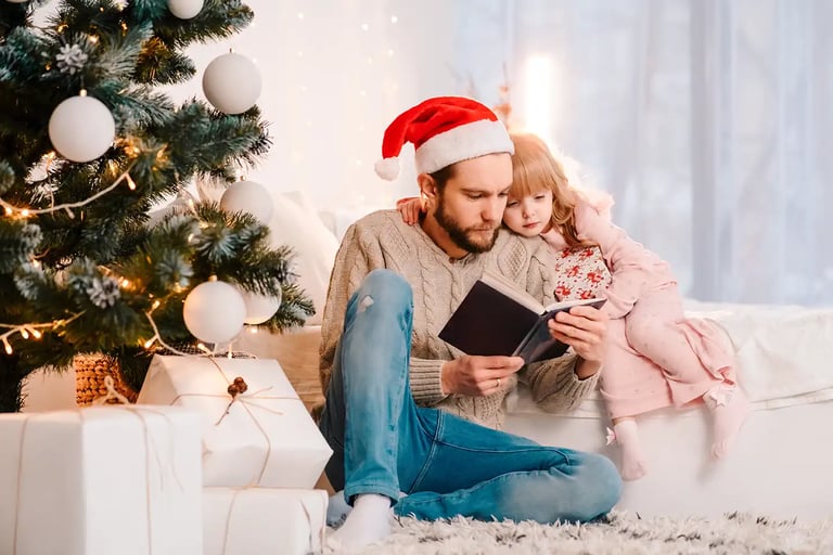 man on couch with daughter reading book