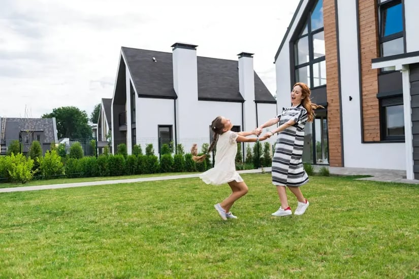 Mother and daughter playing in the garden of an Irish home, illustrating home security while at home