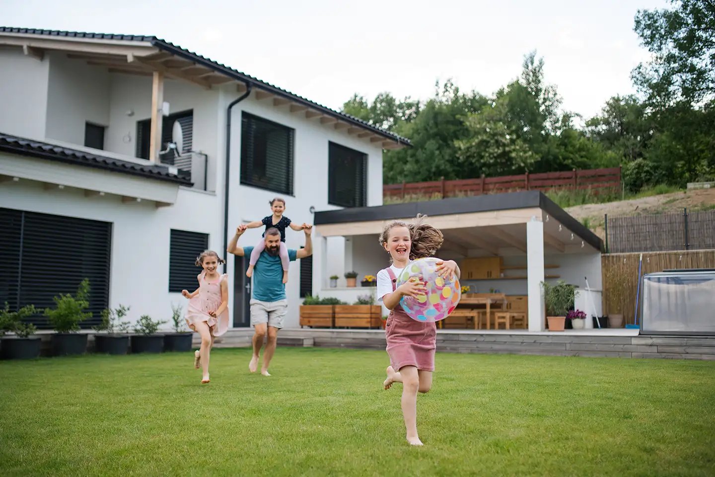 father-with-three-daughters-playing-outdoors