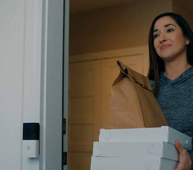 woman answering door accepting a delivery