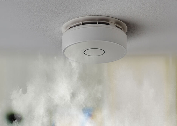 PhoneWatch optical smoke detector on a ceiling detecting smoke from a fire below
