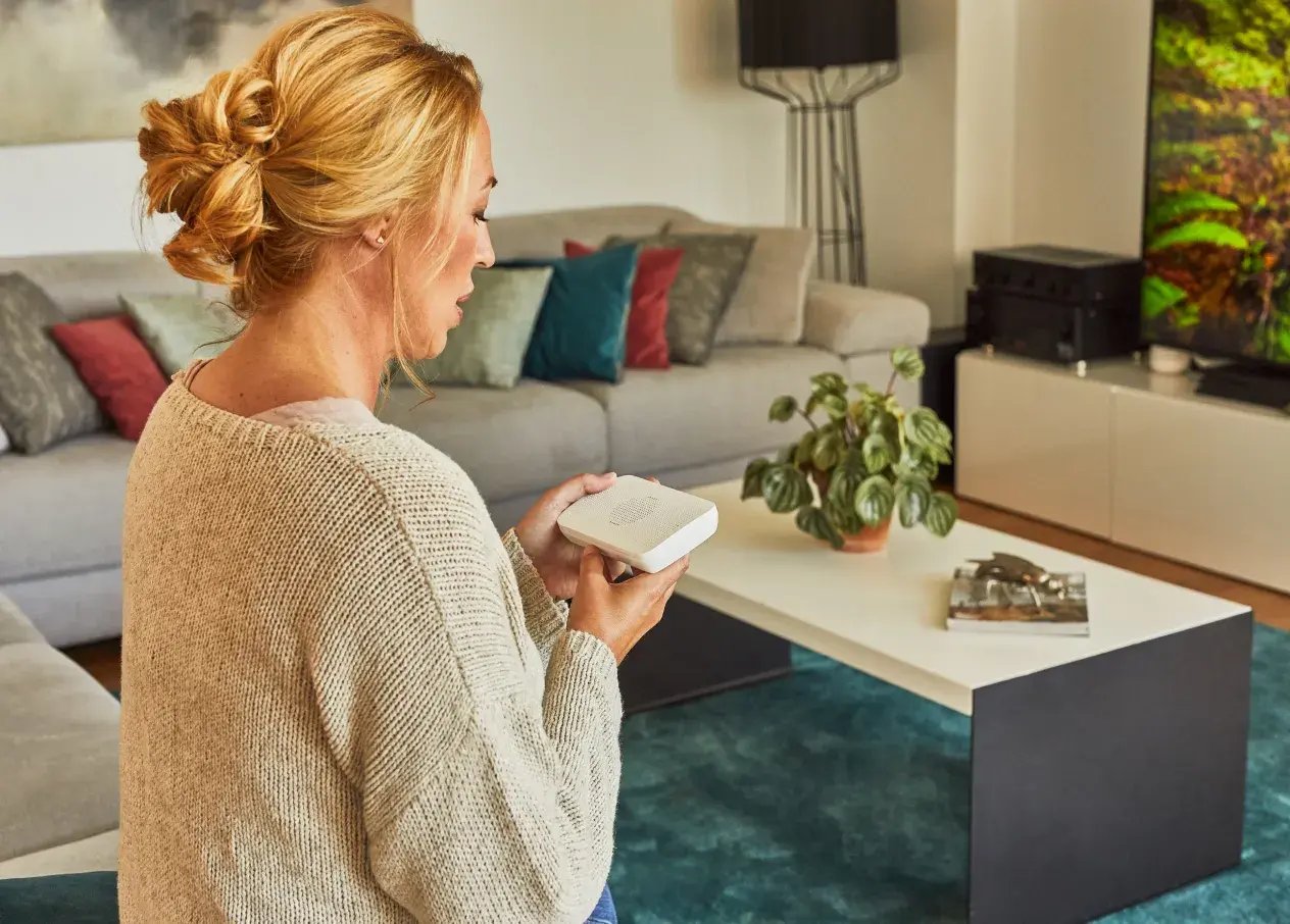 woman looking at sos button on alarm keypad