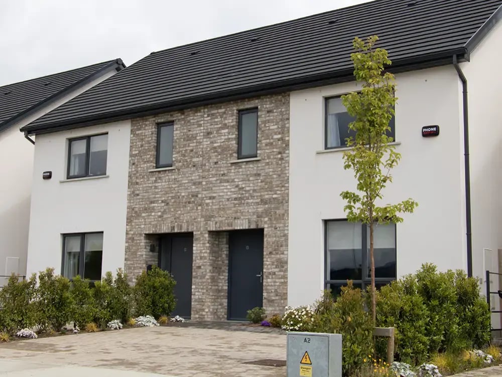 Two‑storey semi‑detached house with front driveway and brick features and phonewatch house alarm