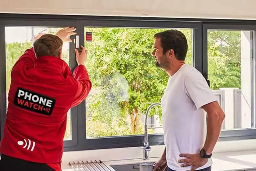 Contact window alarm sensor fitted to a window frame, and Glass break detector mounted on a wall near a window