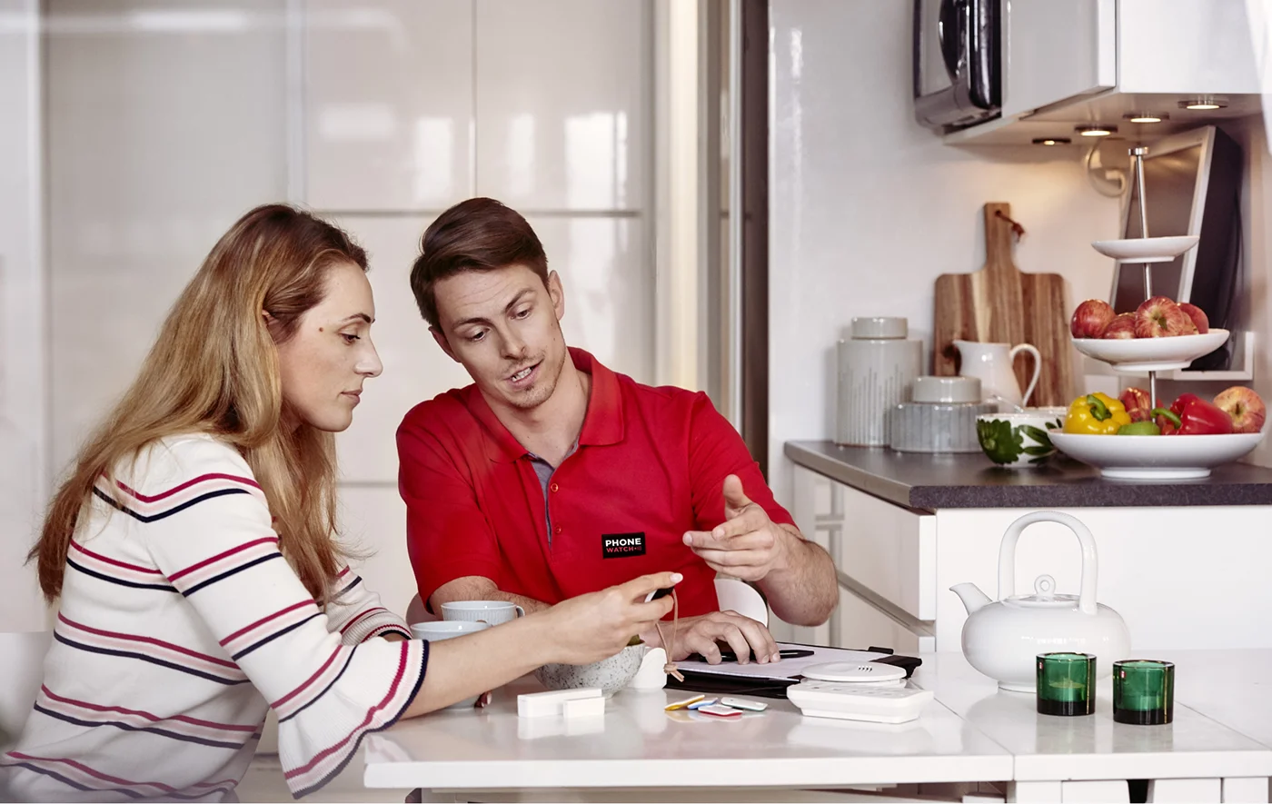 security installer with customer looking at product