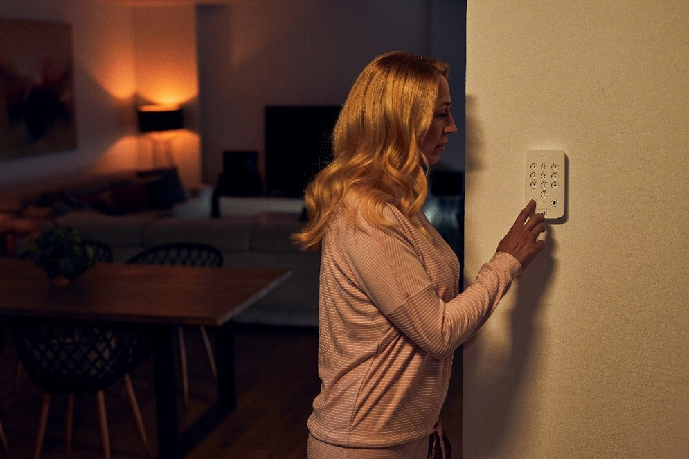 woman arming her house alarm